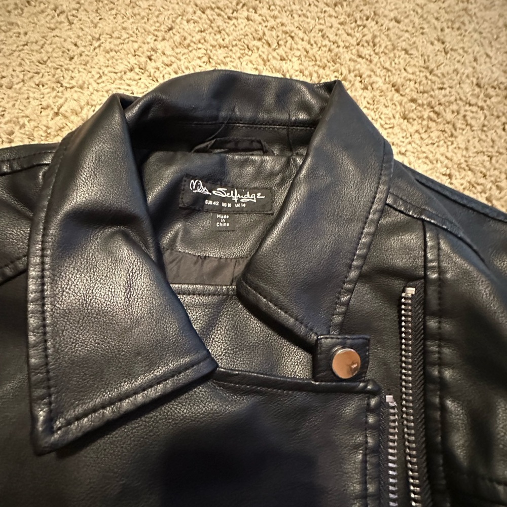 Faux leather accented with zippers, very stylist